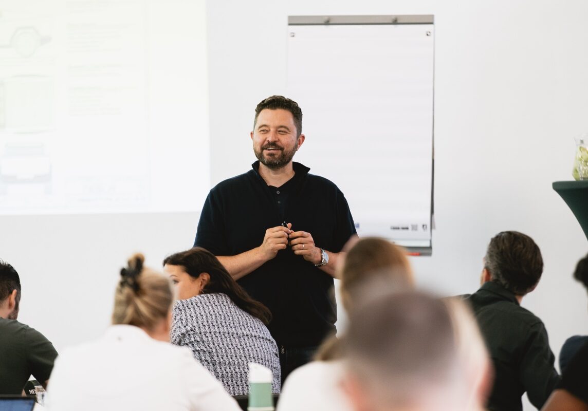 Ondernemers coach geeft een presentatie voor een groep mensen.